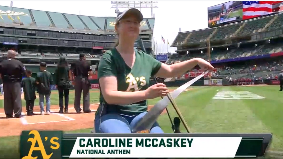 Caroline McCaskey plays national anthem on a saw before Oakland A’s game